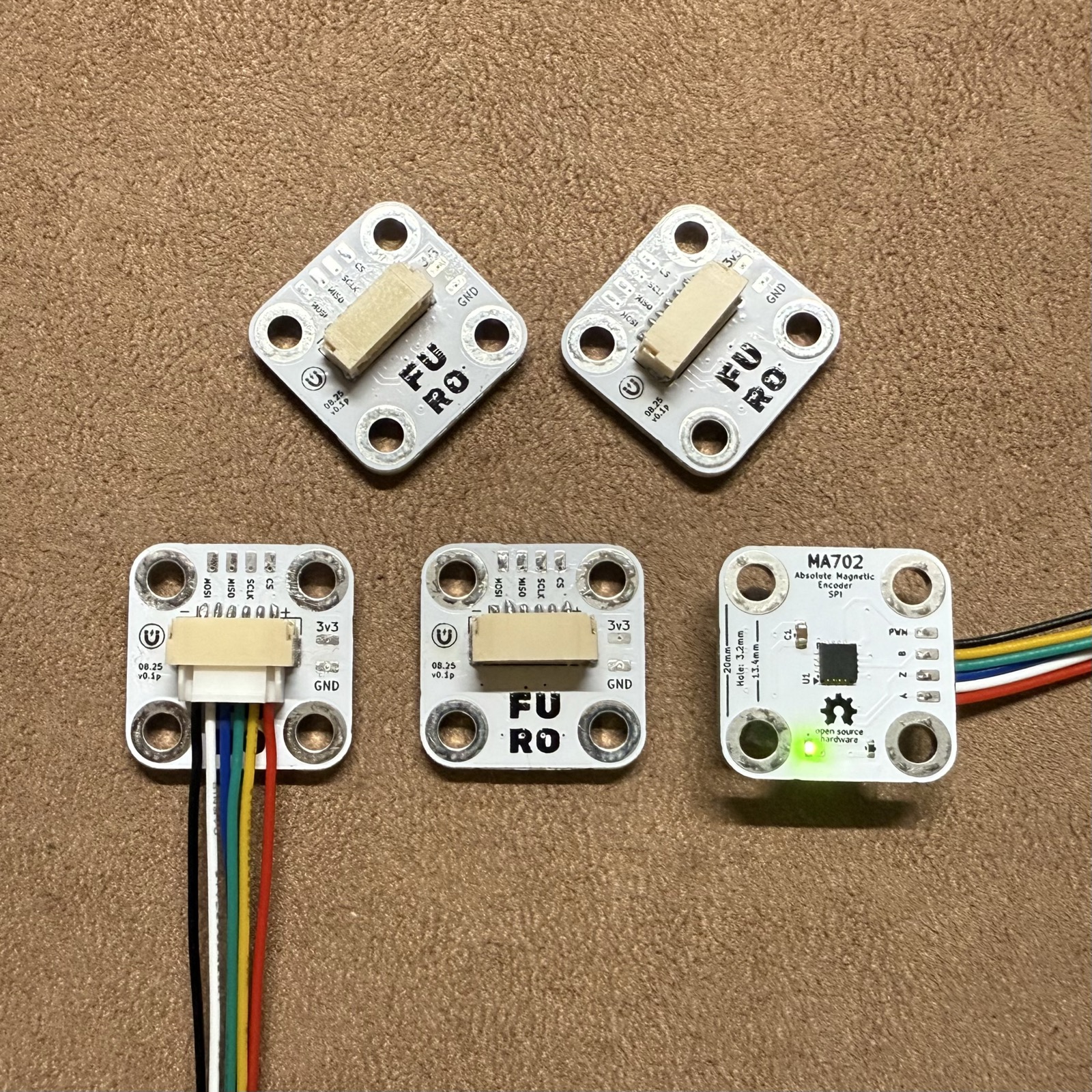 A batch of boards, front and back. 20 mm square, JST connector for SPI.